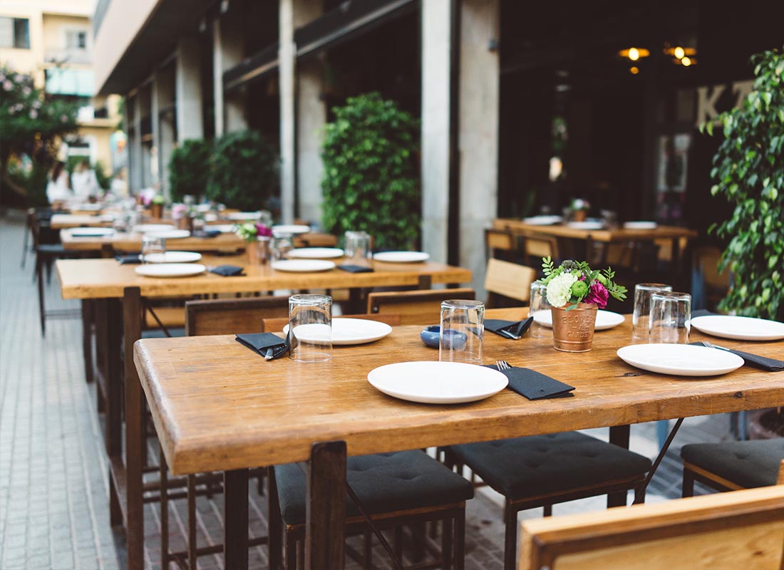Insurance by Industry - Outdoor Restaurant Seating with Wooden Tables During Happy Hour