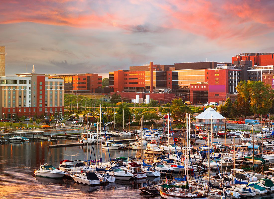 About Our Agency - Aerial View of Erie, PA Skyline With Small Boats in Lake Erie During Sunset