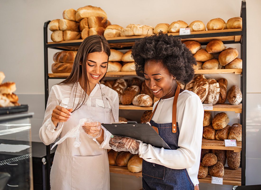 Business Insurance - Two Baker Workers Checking Inventory in a Bakery Shop
